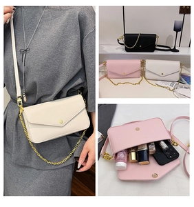 Three-way view of women's envelope crossbody bag with chain detail and internal capacity