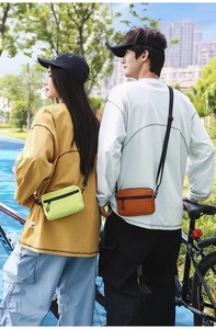 Detail of neon green and burnt orange nylon crossbody bags with adjustable straps