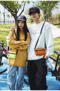 Outdoor cycling lifestyle view of neon green and orange nylon crossbody mini bags