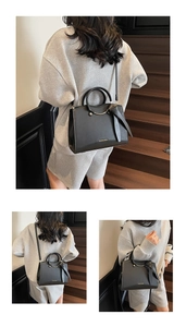 Détail du sac cabas en cuir noir avec anneau doré et ruban décoratif en nœud