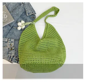 Detail of bright green crochet knit tote bag with hollow out weave for summer beach