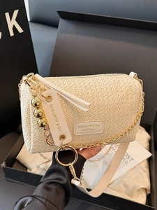 Elegant beige straw handbag with gold chain and woven strap in luxury black gift box