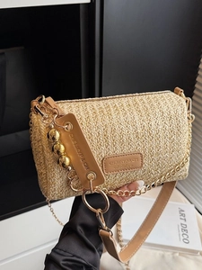 Fashionable straw shoulder bag with gold chain strap and leather accents for summer