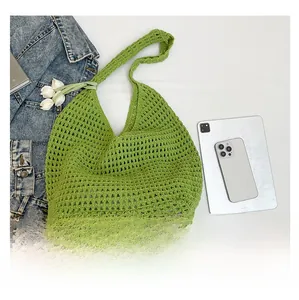 Detail showing green woven cotton tote bag with tulip charms and large hollow mesh texture