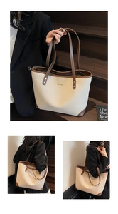 Dettaglio della borsa tote grande con trama litchi crema e rifiniture in pelle marrone