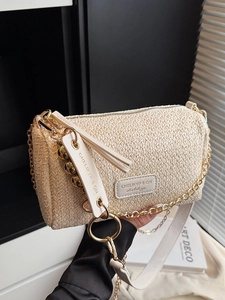 Chic beige woven cylinder straw handbag with gold chain strap and leather branding tag
