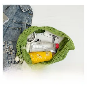 Macro view of green crochet beach bag showing large capacity for essentials