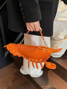 Creative orange lobster shaped crossbody bag with gold rivet details and leather strap