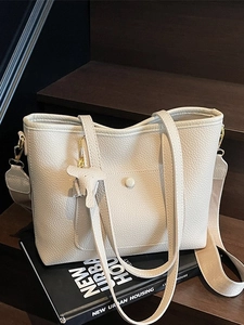 Chic beige leather tote bag with pebble texture and adjustable shoulder straps