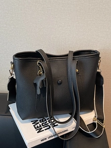 Large black pebble leather tote bag with dual straps and woven shoulder strap