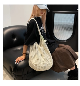 Detail of white hollow crochet tote bag showing woven texture and spacious casual design