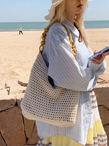 Bohemian crochet beach bag with decorative wooden bead straps and hollow mesh design
