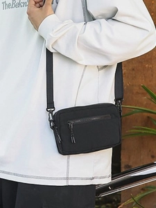 Versatile black nylon crossbody bag for women featuring adjustable strap and zipper pockets