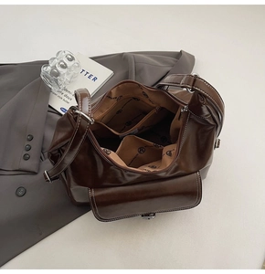 Detail view of the deep brown oil wax leather bag interior with multiple compartments