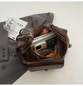 Internal view of dark brown faux leather bag showing large capacity for laptop and daily items