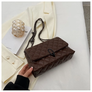 Detailed view of deep brown quilted shoulder bag with chic metal chain and U-shaped lock