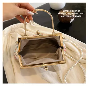 Close-up of vintage floral embroidery evening bag with white pearl chain and spacious interior
