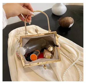 Detailed view of the vintage floral handbag interior with metal handle and pearl strap
