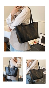 Vue détaillée du grand sac cabas noir à motif crocodile et logo doré élégant