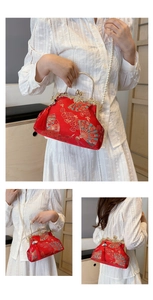 Detail of red Chinese embroidery evening bag with silk tassel and pearl chain strap