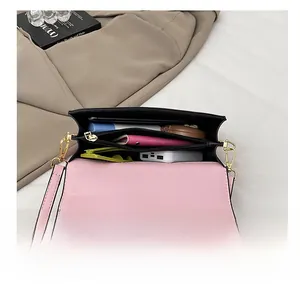 Detailed interior of the pink shoulder bag showing multiple compartments and daily essentials