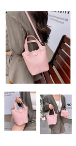 Detail of pink lychee leather bucket bag with top handles and a matching mini pouch