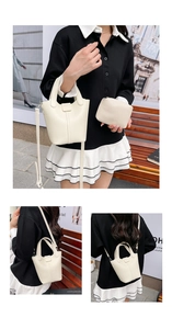 Detailed view of creamy white lychee grain leather bucket bag set with detachable strap