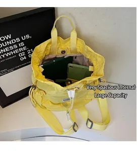 Macro view of yellow drawstring bucket bag showing large capacity for tablet and phone