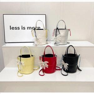 Mini bucket bags in multiple colors with floral charms and detachable shoulder straps