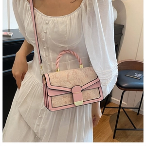 Pink shoulder bag with butterfly embroidery and unique twisted rope handle detail