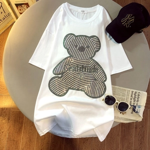 Detail of white cotton oversized T-shirt featuring a shimmering rhinestone bear design