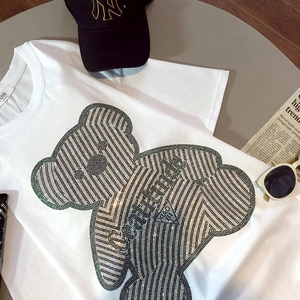 Close-up of rhinestone teddy bear design with Cattitude text on white cotton t-shirt