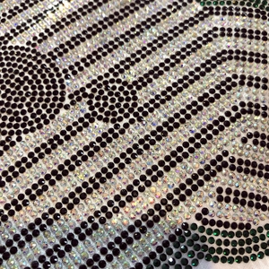 Detail view of premium rhinestone teddy bear pattern with sparkling black and green gems