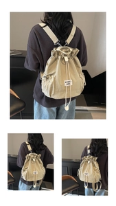 Detail of beige nylon drawstring backpack with adjustable closure and minimalist logo patch
