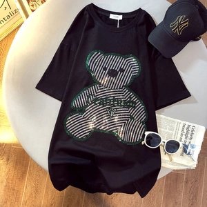 Detailed view of black cotton T-shirt featuring a sparkling green rhinestone bear motif
