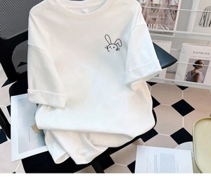 Detail eines weißen Baumwoll-T-Shirts mit minimalistischem schwarzen Kaninchenaufdruck