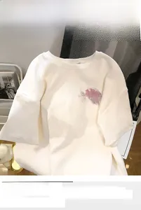 Detail of white cotton T-shirt featuring a pink splash DARLING print on a loose fit