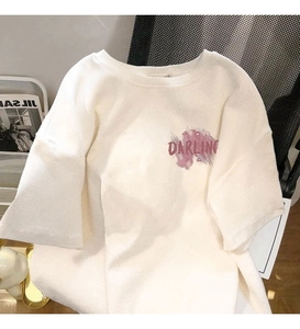 Detail of white cotton T-shirt featuring purple ink splash and Darling letter print