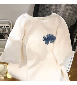 Close-up of cream cotton t-shirt featuring blue darling graffiti print and round neck