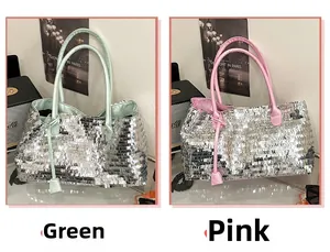 Detail view of silver sequin tote bags with pink and mint green leather handles and charms