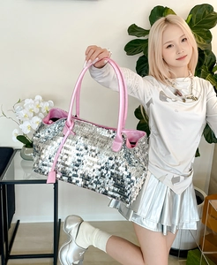 Detail of large tote bag with silver square sequins and contrasting pink handles