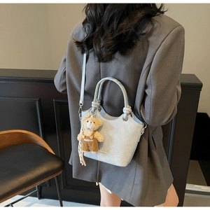 Light blue crocodile pattern shoulder bag with a cute brown plush bear charm