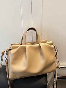 Large beige leather tote bag with pleated cloud design and textured lychee pattern finish