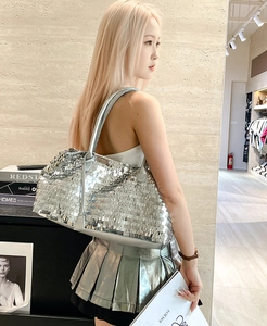 Silver sequin tote bag with metallic rectangular scales shown on model shoulder
