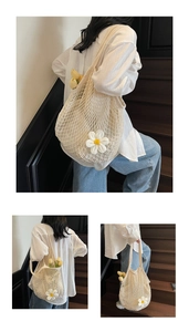 Detailed view of large cotton mesh tote bag with inner lining and white flower accent