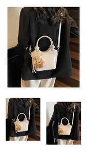 Detail of white crocodile pattern bucket bag with bear charm and adjustable strap
