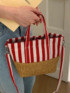 Red and white striped canvas handbag with woven base and detachable shoulder strap