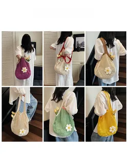 Detail of colorful cotton mesh bags with inner lining and decorative 3D white daisies