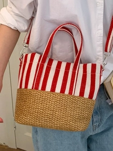 Striped canvas and woven straw tote bag with red and white patterns and shoulder strap