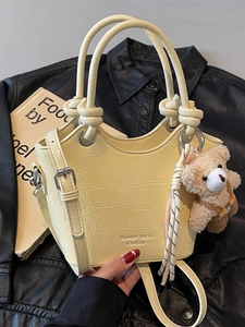 Minimalist yellow crocodile pattern bucket bag with ring handles and plush bear charm
